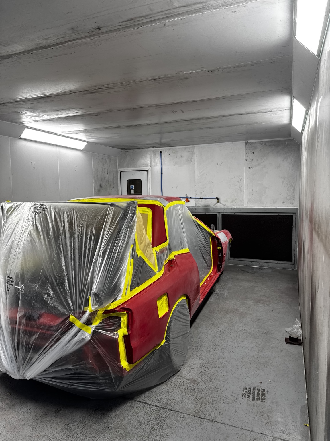 Vehicle masked and prepared for paint