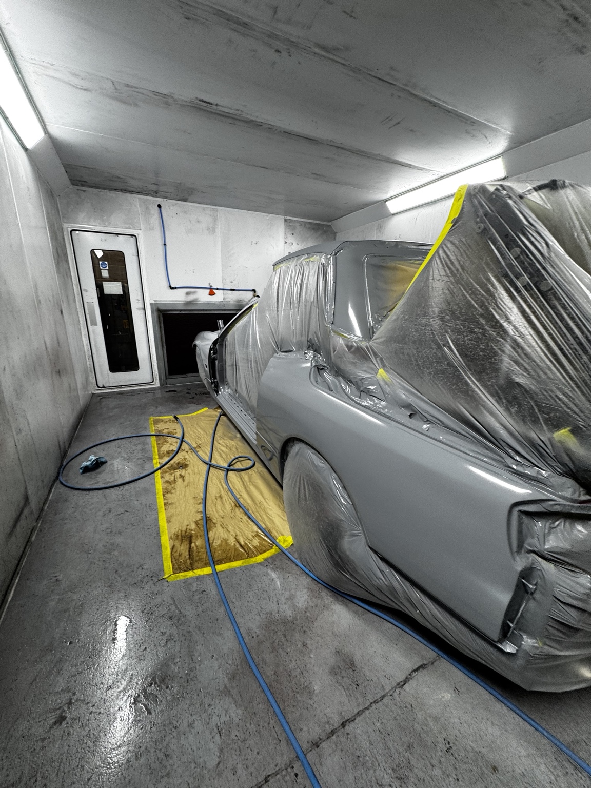 Vehicle being painted in the spray booth